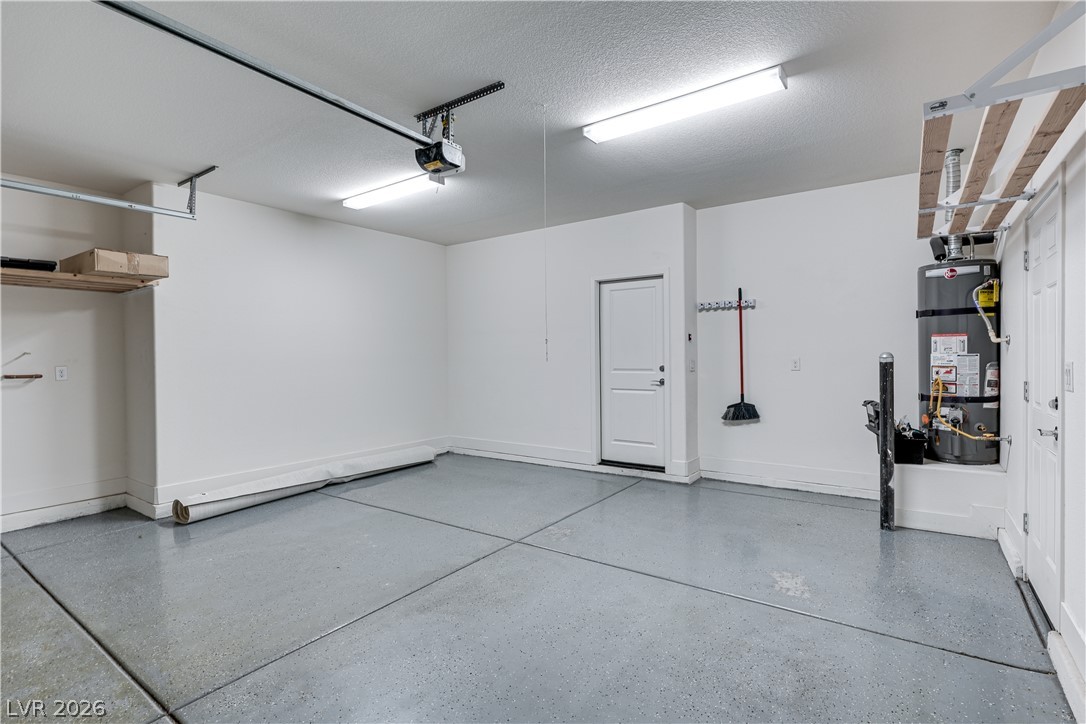 5954 Smith Valley Road Las Vegas, NV 89148 - Photo 7 of 23 A pristine garage with a sleek gray floor offers practical storage and direct home access.