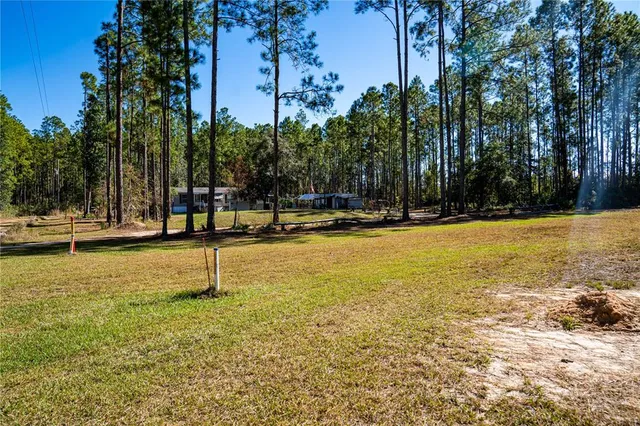 a swimming pool with outdoor seating and yard