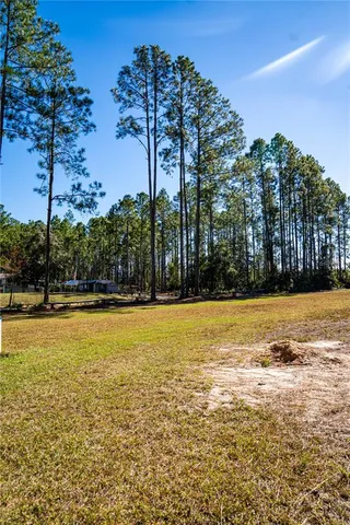 a swimming pool with outdoor seating and yard