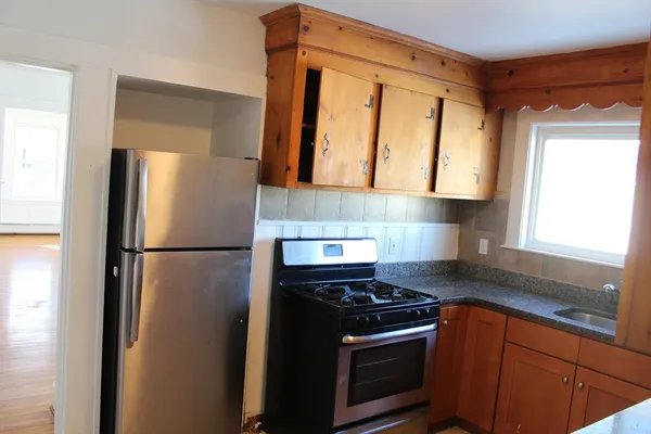 a kitchen with a refrigerator stove and cabinets