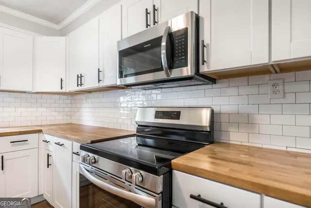 a kitchen with a stove microwave and sink