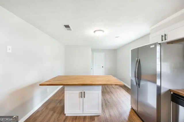 a kitchen with a wooden floor and entryway