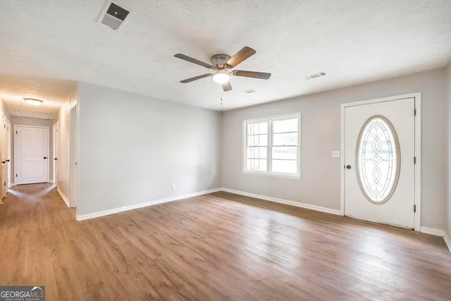 wooden floor in an empty room with a window