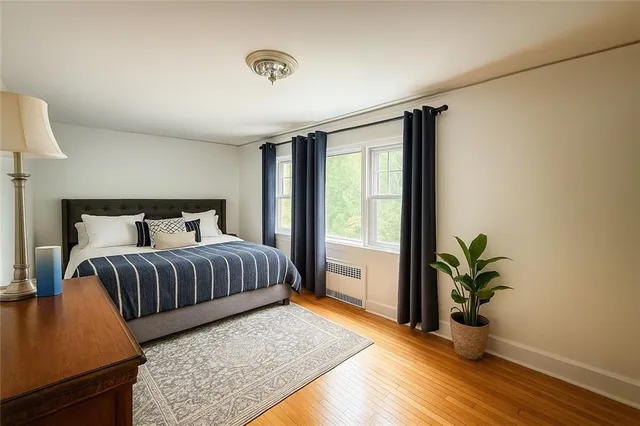 a bedroom with a balcony a bed and a potted plant