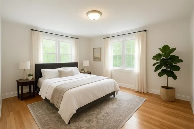 a bedroom with a large bed and a chandelier