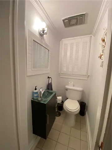 a bathroom with a sink toilet and a mirror