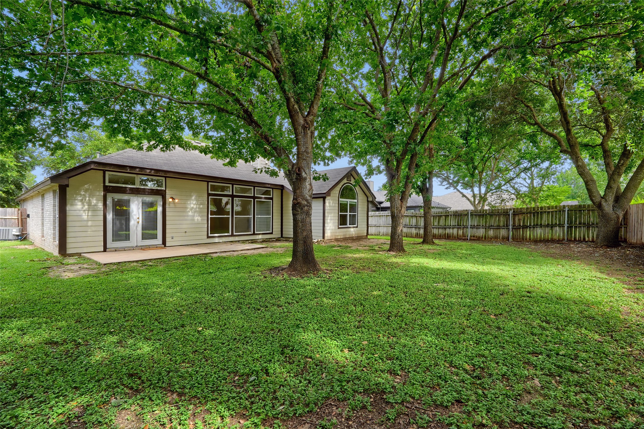 119 Stephen Lane Georgetown, TX 78626 - Photo 2 of 32 A spacious backyard with mature shade trees, offering ample room for outdoor activities and private gatherings.