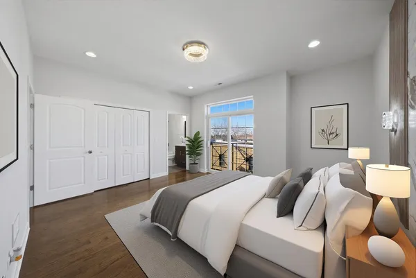 a bedroom with a bed and a potted plant