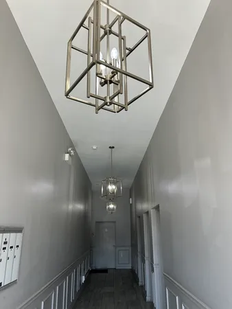 a view of a hallway with wooden floor and entryway