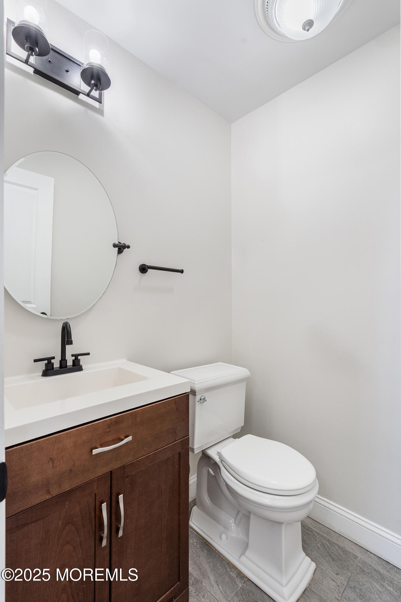 7 Longfellow Court Freehold, NJ 07728 - Photo 12 of 38 a bathroom with a sink a toilet and mirror