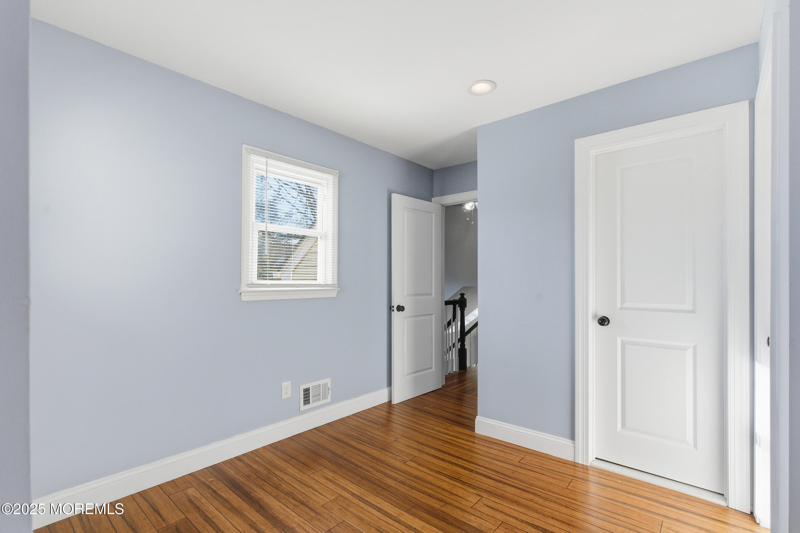 7 Longfellow Court Freehold, NJ 07728 - Photo 18 of 38 a view of an empty room with wooden floor and a window