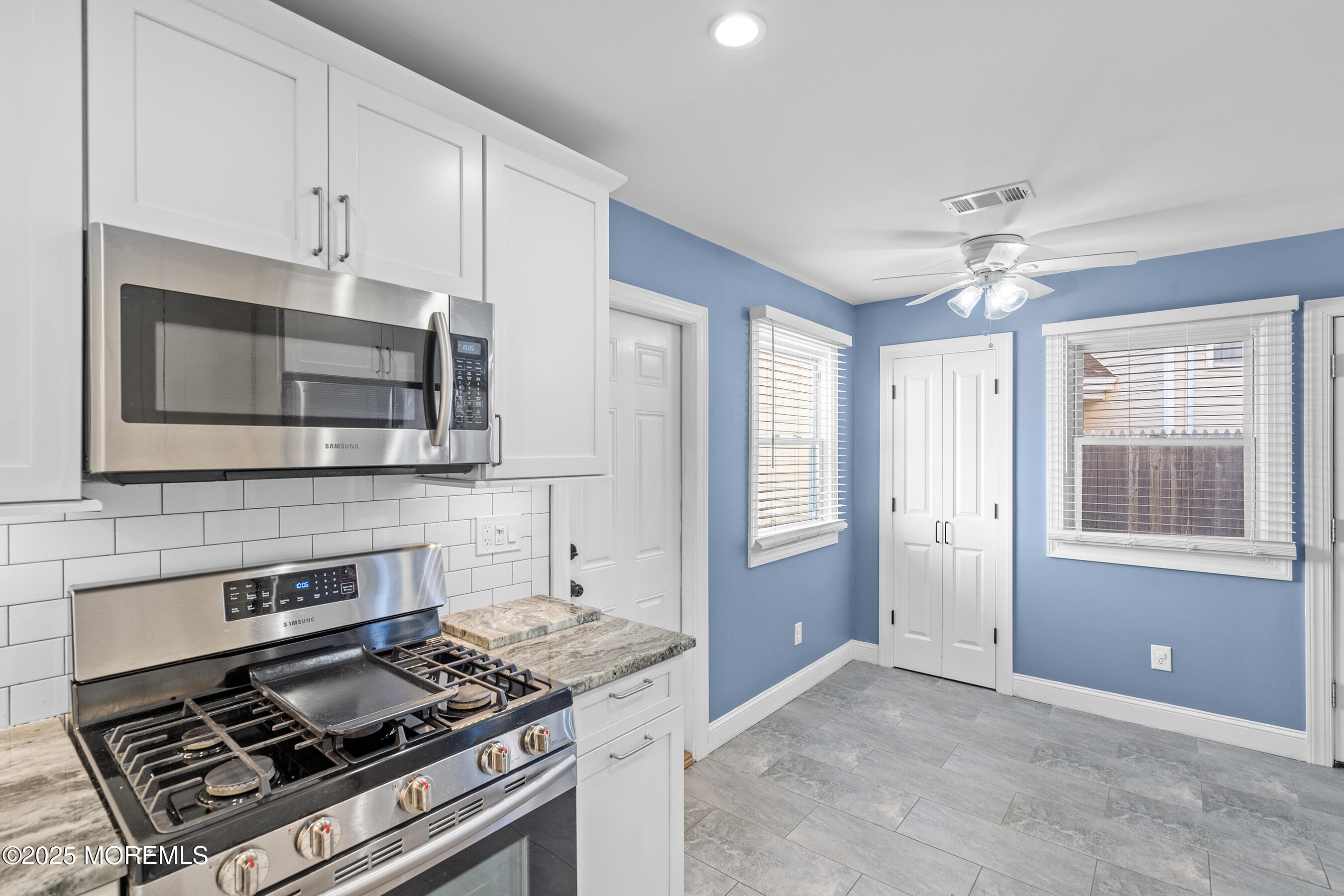 7 Longfellow Court Freehold, NJ 07728 - Photo 5 of 38 a kitchen with stainless steel appliances a stove a microwave and cabinets