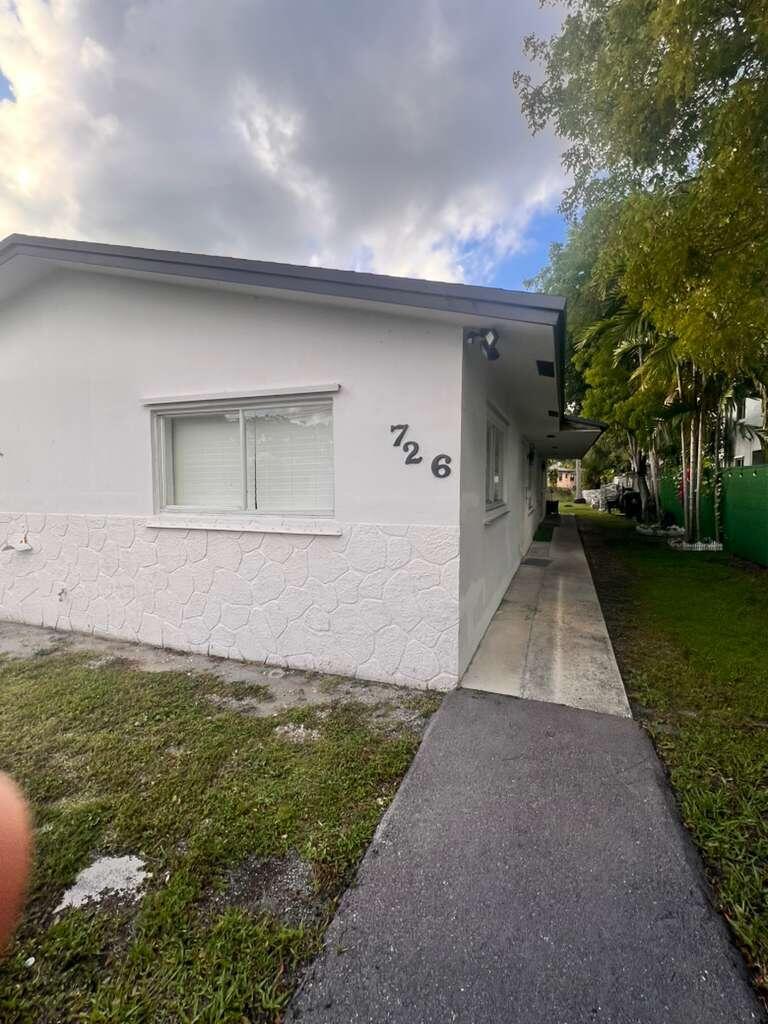 726 Southwest 7th Street, Unit 12 Hallandale Beach, FL 33009 - Photo 1 of 5 a view of outdoor space and yard