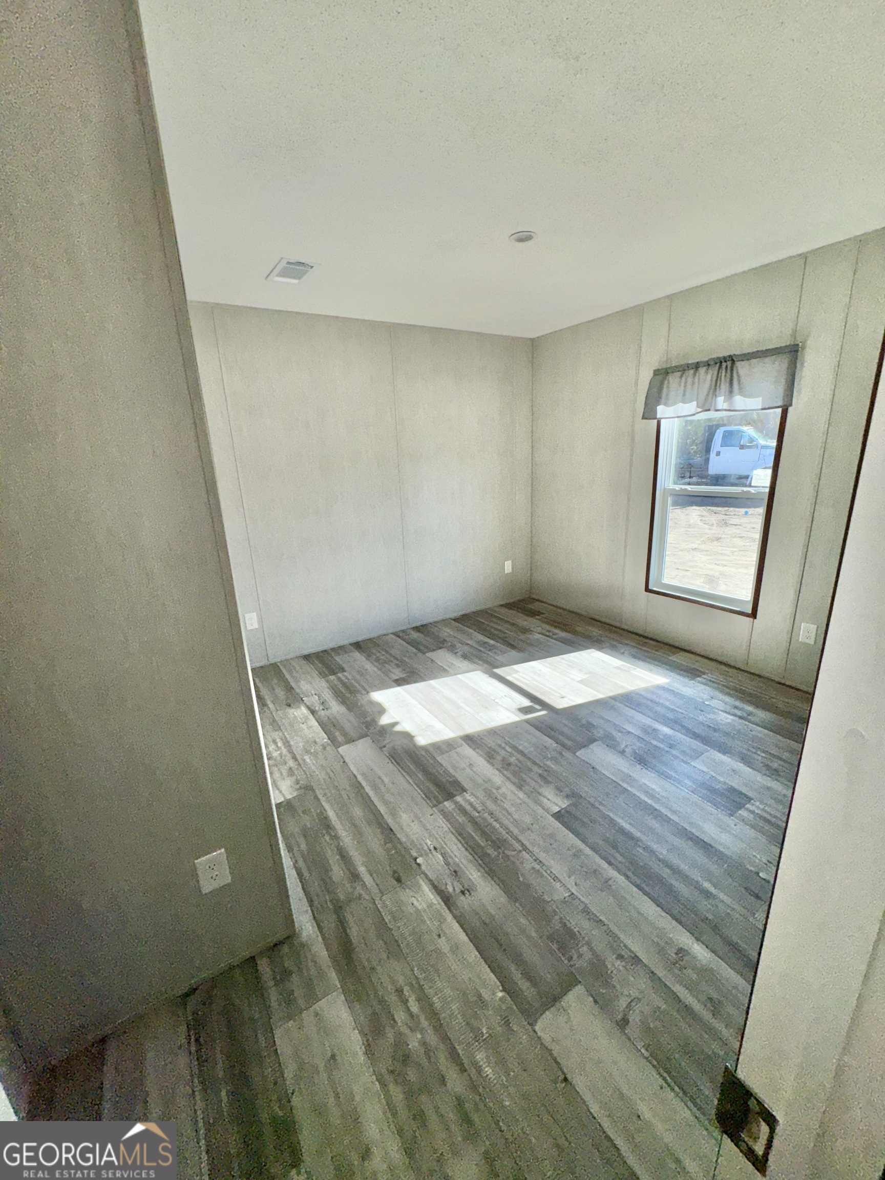 589 Ben Jackson Road Vidalia, GA 30474 - Photo 13 of 17 a view of livingroom with window and hardwood floor