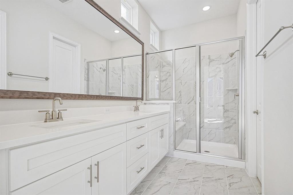 11458 Chartwell Court Frisco, TX 75035 - Photo 17 of 32 a bathroom with a shower sink and mirror