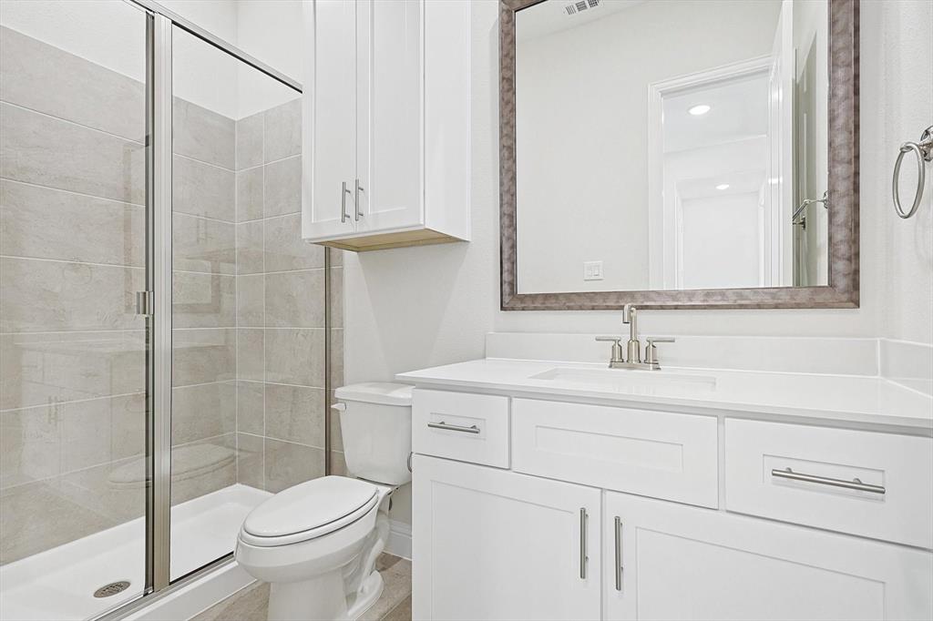 11458 Chartwell Court Frisco, TX 75035 - Photo 19 of 32 a bathroom with a sink toilet and shower