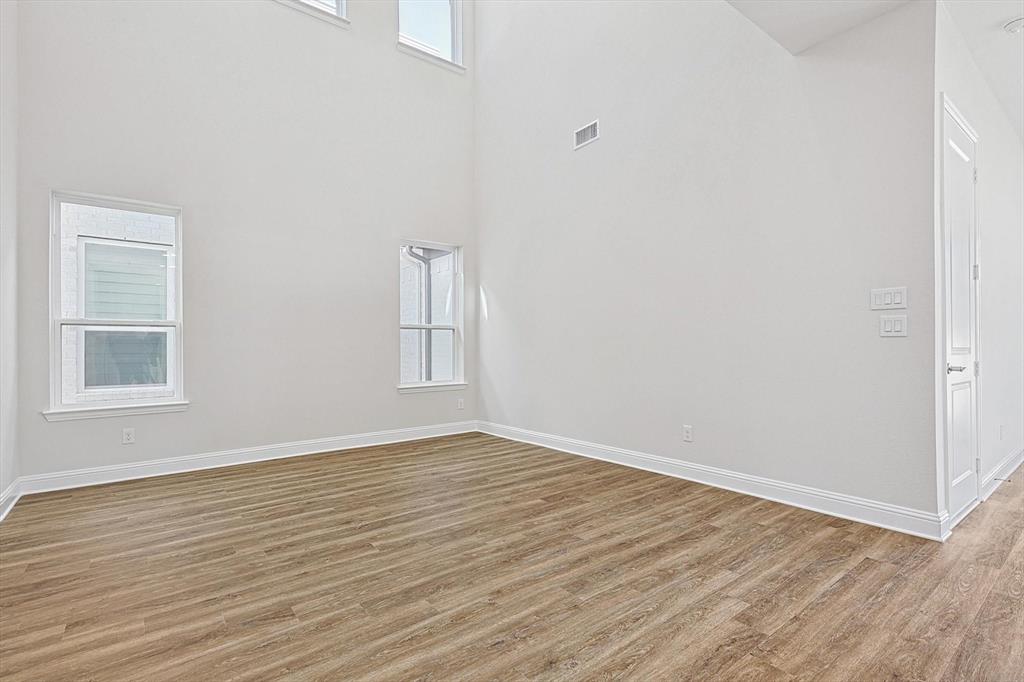 11458 Chartwell Court Frisco, TX 75035 - Photo 6 of 32 a view of an empty room with wooden floor and a window