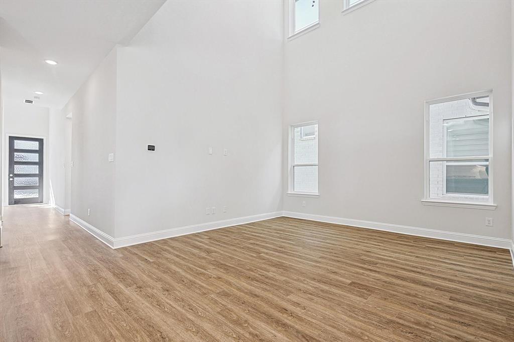 11458 Chartwell Court Frisco, TX 75035 - Photo 7 of 32 a view of an empty room with wooden floor and a window