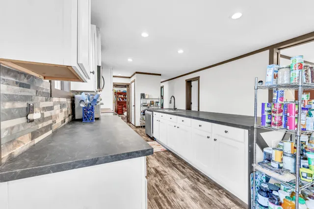 a bathroom with a double vanity sink a mirror and a bathtub