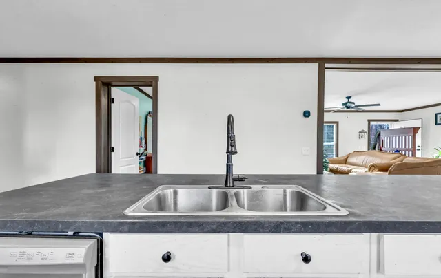 a bathroom with a granite countertop double vanity sink and a mirror