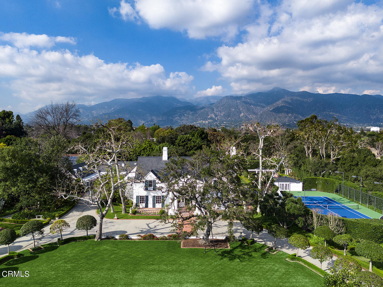 a view of a city with lots of residential buildings ocean and mountain view in back