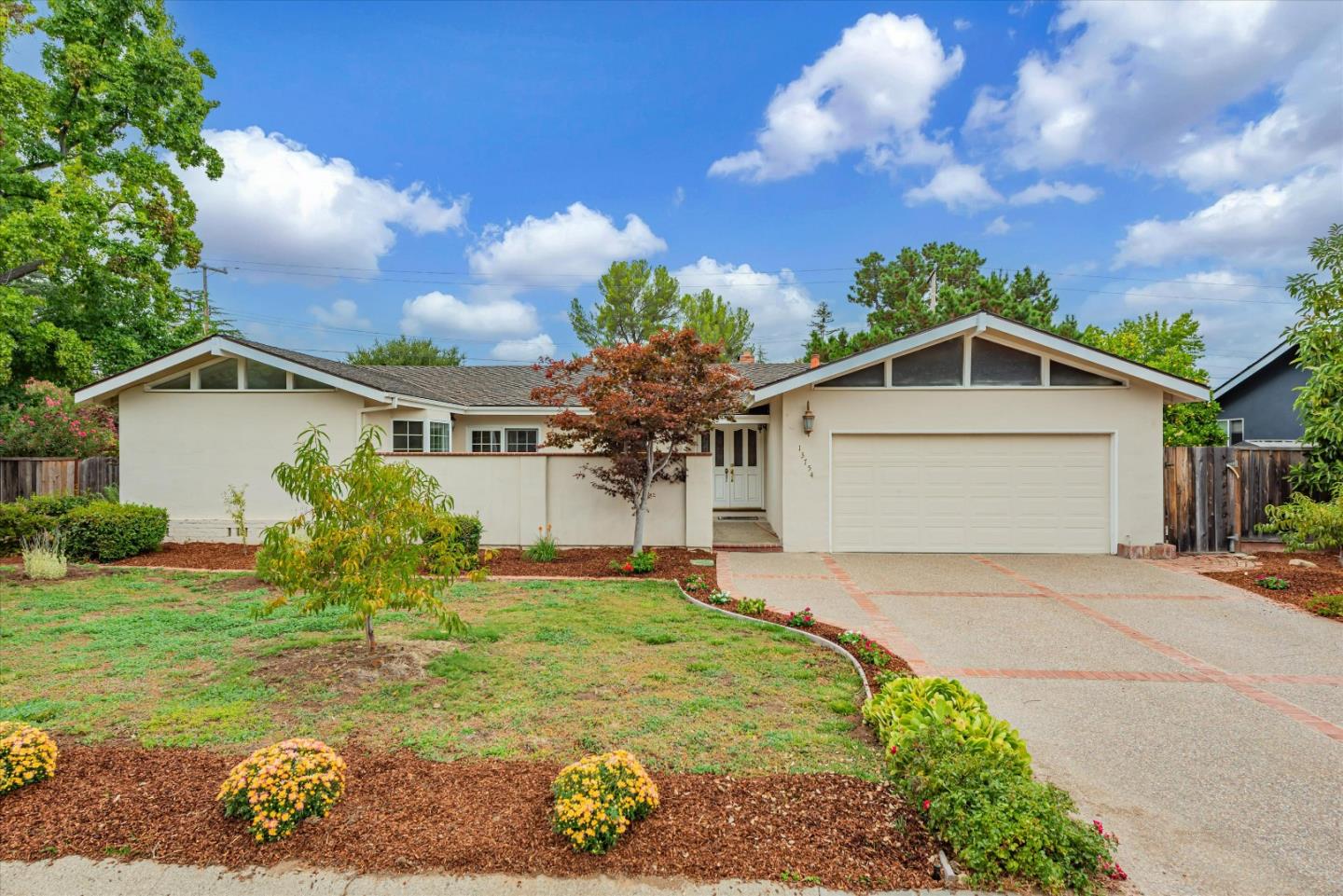 a front view of house with yard and trees