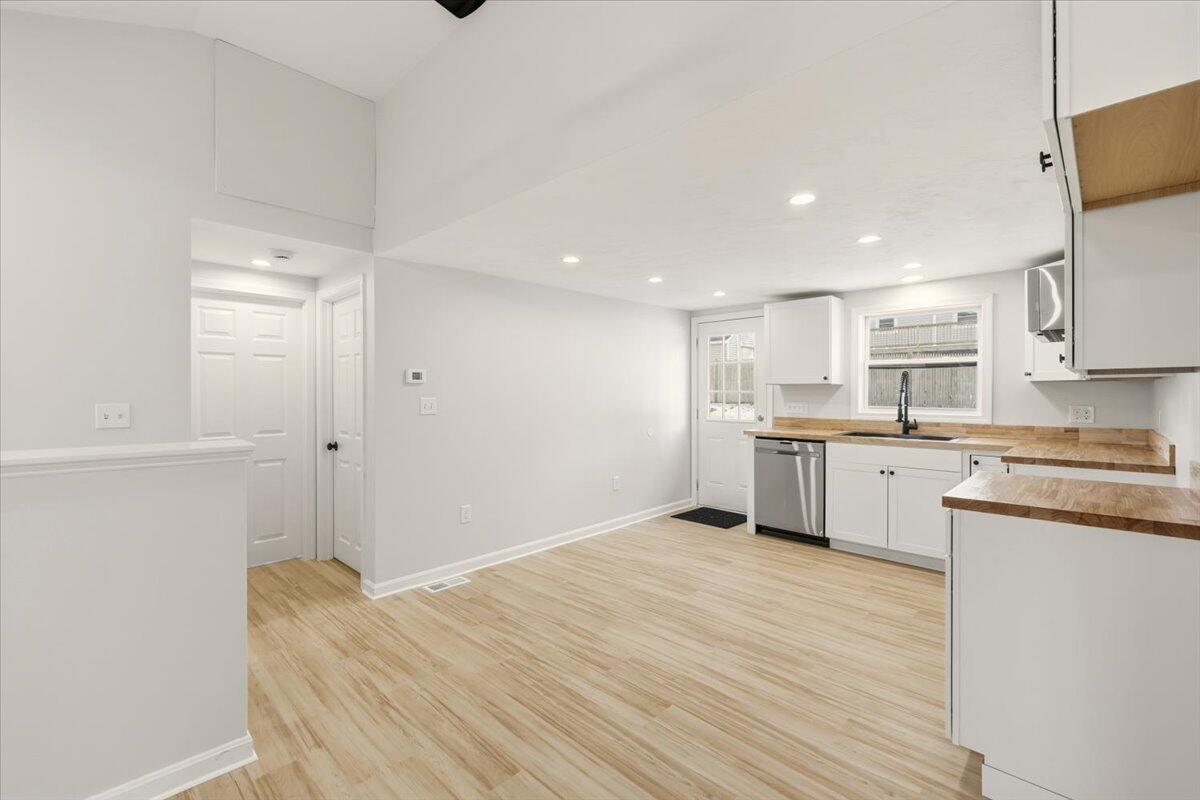 9 Blissful Lane East Wareham, MA 02538 - Photo 11 of 45 a open kitchen with white cabinets and wooden floor