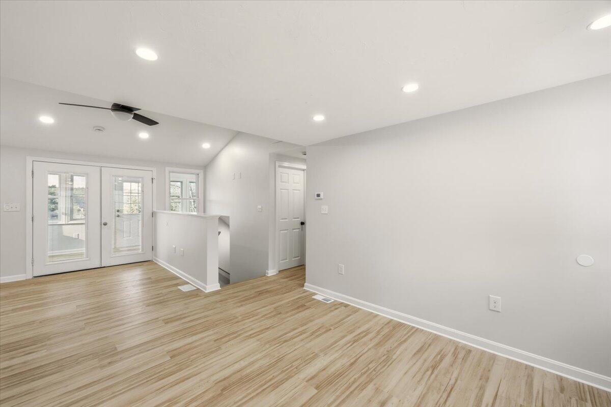 9 Blissful Lane East Wareham, MA 02538 - Photo 16 of 45 a view of an empty room with wooden floor and a window