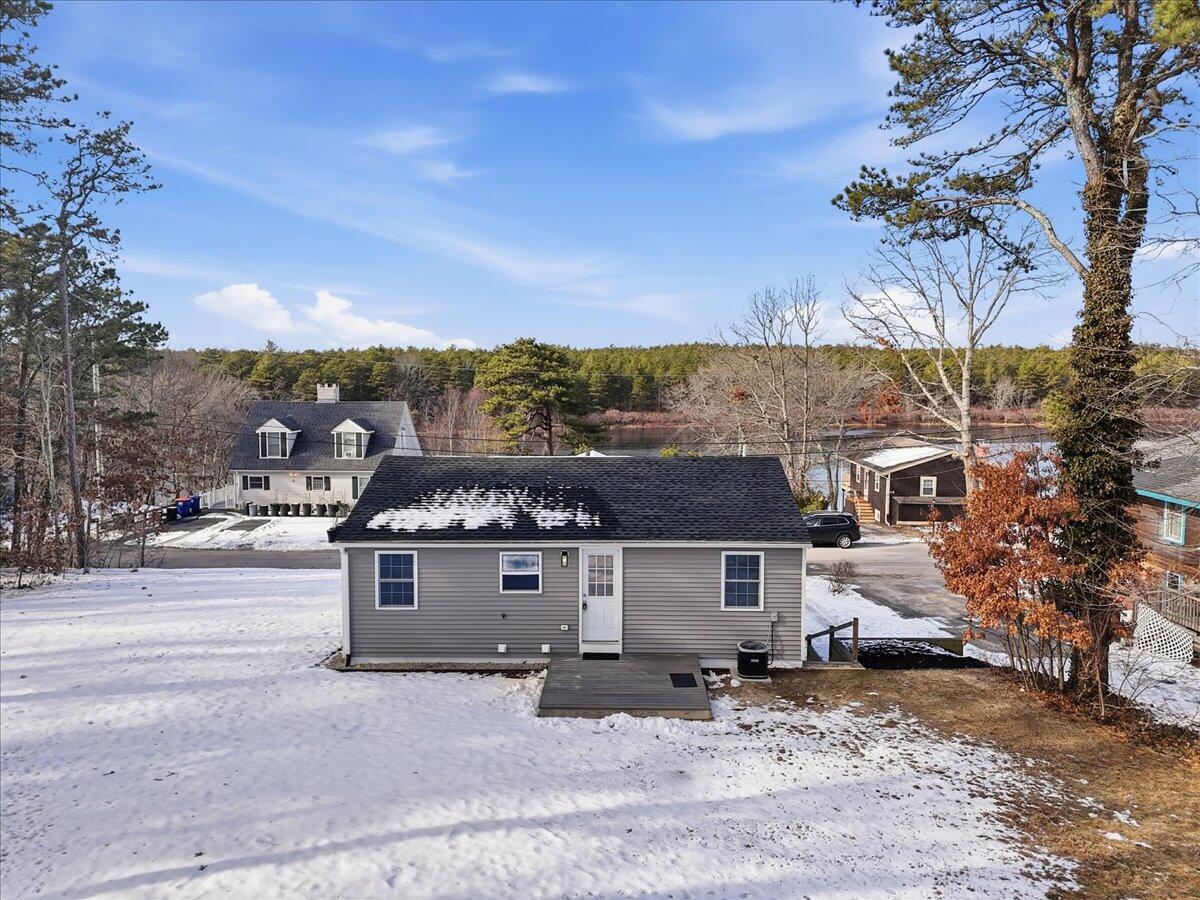 9 Blissful Lane East Wareham, MA 02538 - Photo 4 of 45 a front view of a house with a yard and garage