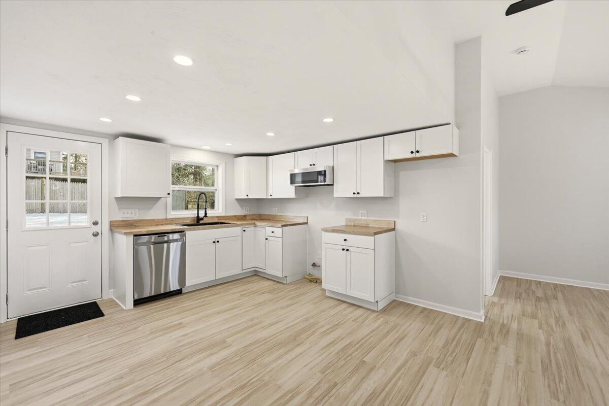 9 Blissful Lane East Wareham, MA 02538 - Photo 7 of 45 a kitchen with granite countertop white cabinets and white appliances