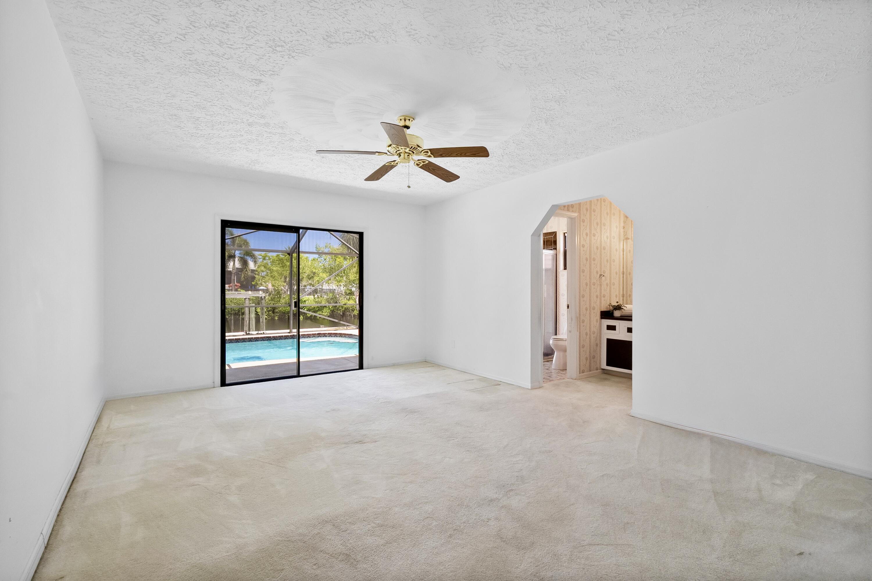 1545 Southwest Dyer Point Road Palm City, FL 34990 - Photo 28 of 44 Primary suite-private entrance to lanai.