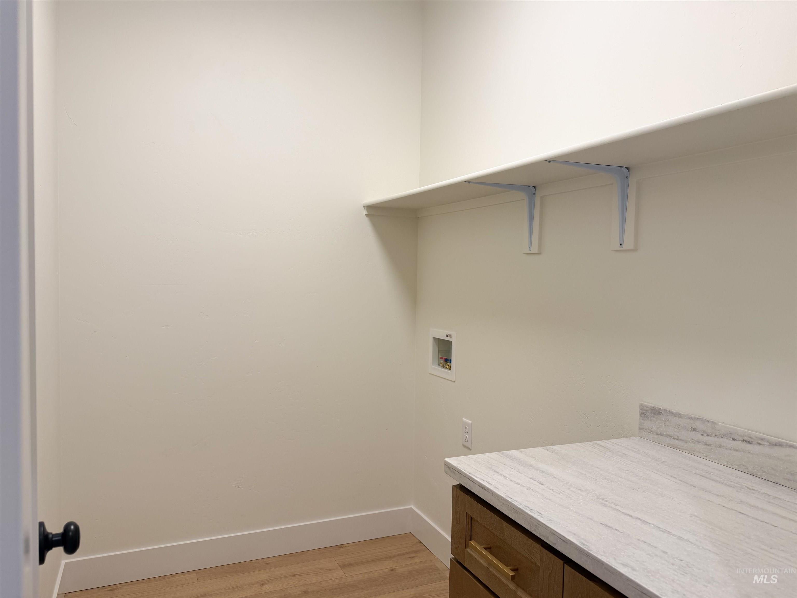 245 Whitman Street Albion, ID 83311 - Photo 13 of 15 Laundry area featuring washer hookup and light wood-style flooring