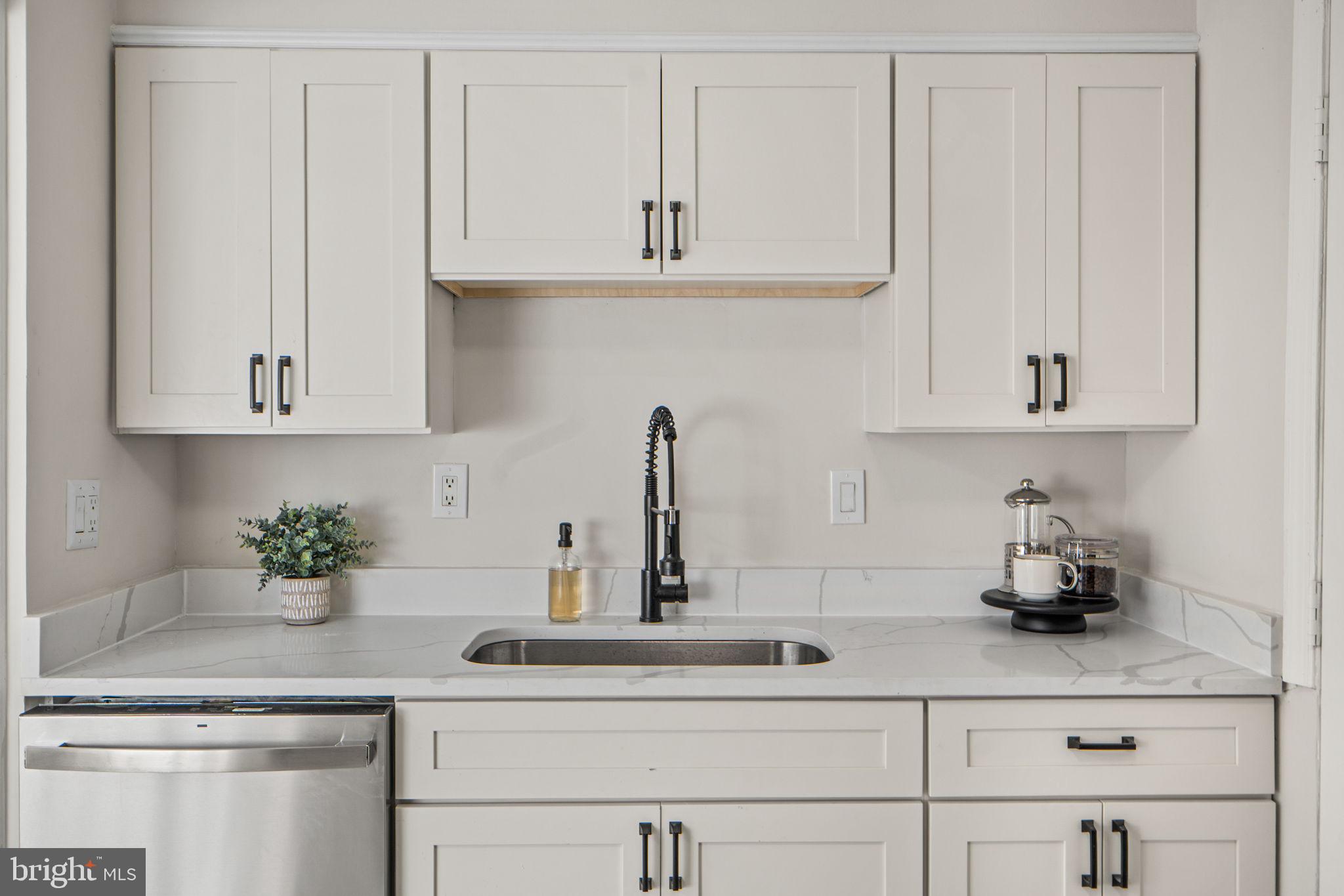 1513 Flora Lane Silver Spring, MD 20910 - Photo 15 of 49 a kitchen with white cabinets and a sink