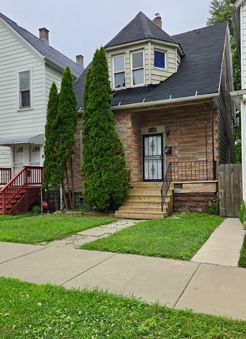 7726 South Maryland Avenue Chicago, IL 60619 - Photo 2 of 17 a front view of a house with a garden