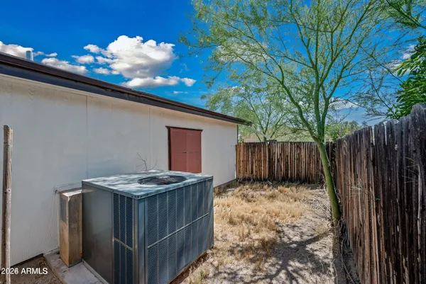 a view of backyard with wooden fence