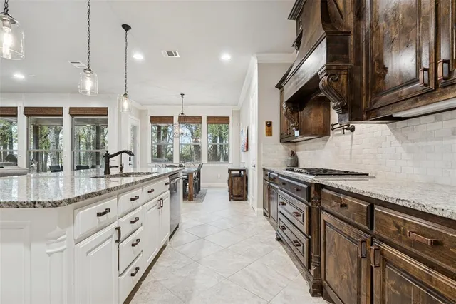 a large kitchen with stainless steel appliances granite countertop a stove and a sink