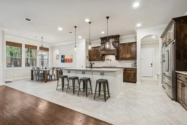 a large kitchen with a table and chairs