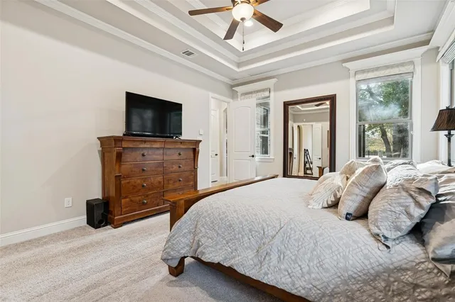 a bedroom with a bed and a television