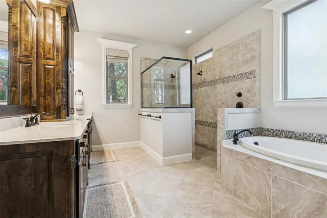 a bathroom with a tub sink and mirror