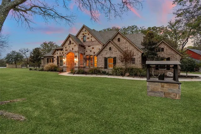 a front view of a house with a garden and sitting area