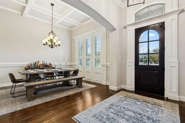 a living room with furniture a dining table and a window