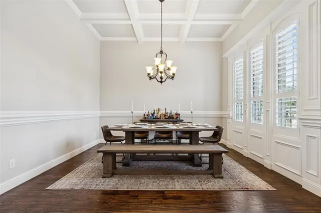 a view of a dining room with furniture a chandelier and wooden floor
