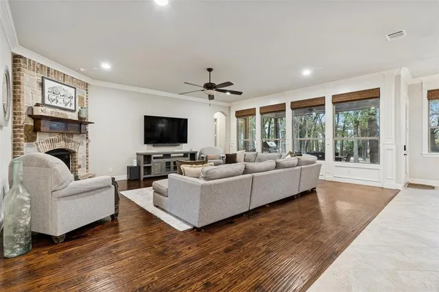 a living room with furniture a flat screen tv and a fireplace