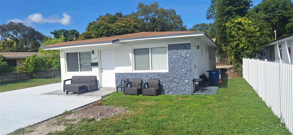 1555 Northeast 148th Street Miami, FL 33161 - Photo 1 of 14 a front view of a house with a garden