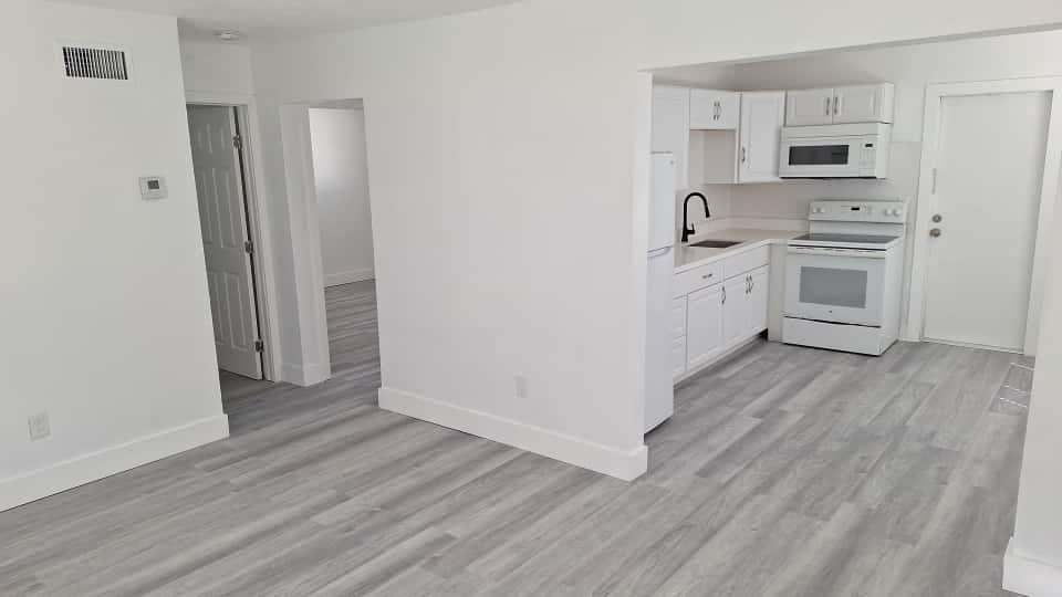 1555 Northeast 148th Street Miami, FL 33161 - Photo 3 of 14 a view of kitchen with wooden floor and electronic appliances