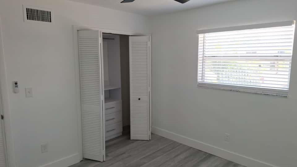 1555 Northeast 148th Street Miami, FL 33161 - Photo 6 of 14 a view of an empty room with wooden floor and a window