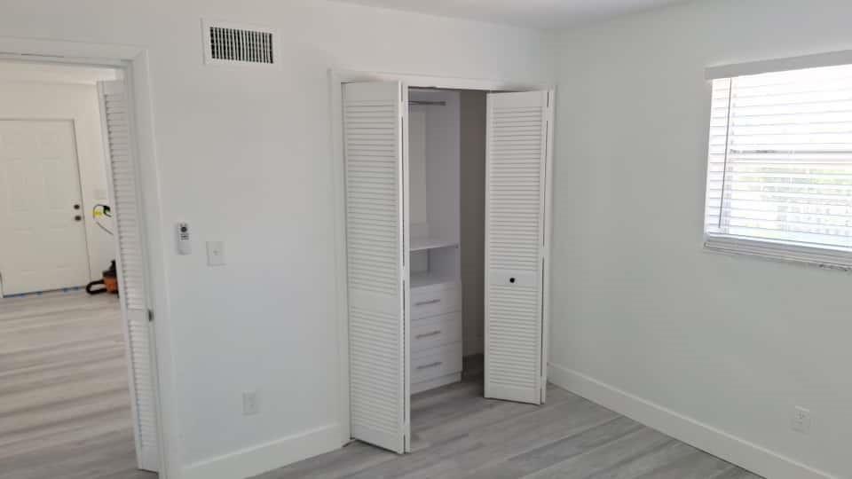 1555 Northeast 148th Street Miami, FL 33161 - Photo 7 of 14 an empty room with wooden floor and windows