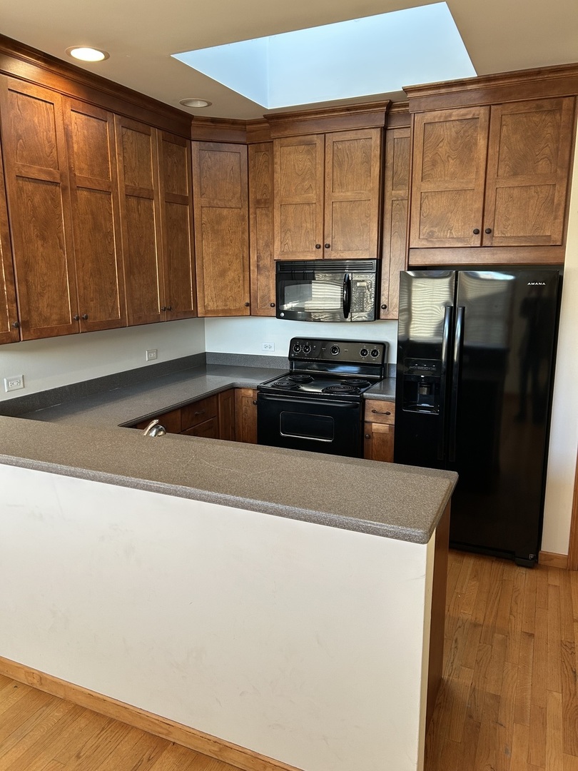116 North Main Street, Unit 5 Wheaton, IL 60187 - Photo 3 of 8 a kitchen with stainless steel appliances a refrigerator a sink a stove a cabinets and a counter top space