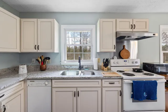 a kitchen with stainless steel appliances granite countertop a stove and a sink