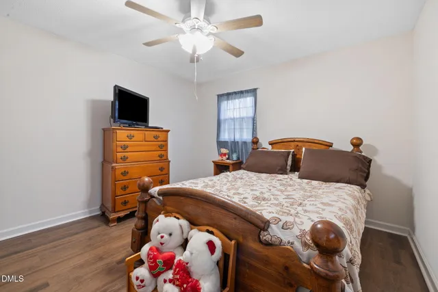 a bedroom with a bed and a tv